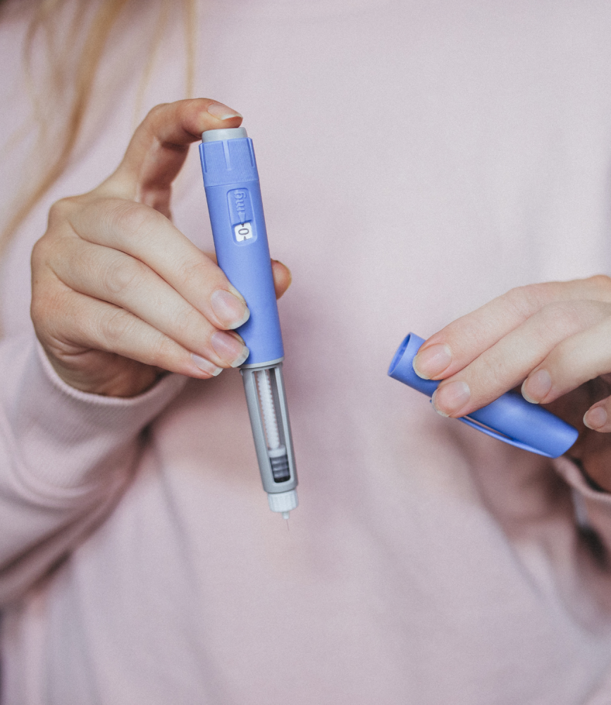 woman holding glp-1 applicator