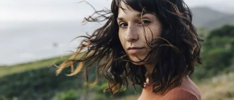 A woman outside with healthy hair blowing in the breeze