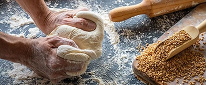 A baker kneading dough