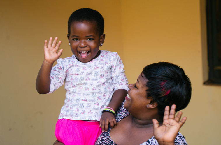 woman with her happy, waving daughter