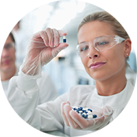 Lab technician inspecting pharmacuetical ingredients
